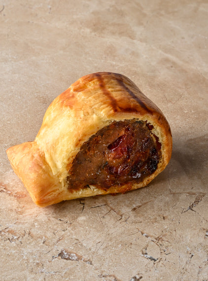 Baby poached ham hock and sage sausage rolls with poached orange peel