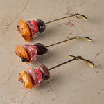 Bray cured salami, griddled apricot, black olive, pickled radish skewer