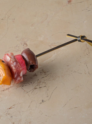 Bray cured salami, griddled apricot, black olive, pickled radish skewer