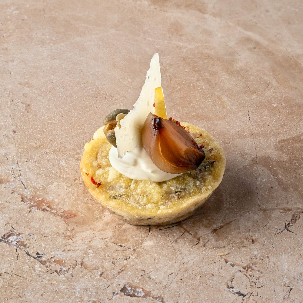 Cheddar and sauté onion frittata, aged Manchego, caper, balsamic shallot, zest, lemon crème (GF)