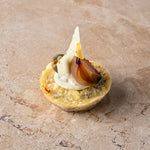 Cheddar and sauté onion frittata, aged Manchego, caper, balsamic shallot, zest, lemon crème (GF)