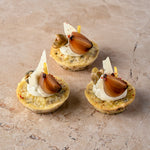 Cheddar and sauté onion frittata, aged Manchego, caper, balsamic shallot, zest, lemon crème (GF)
