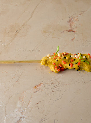Chicken satay skewer, almond crumb, coriander cress, chopped chilli, nigella seed (GF)