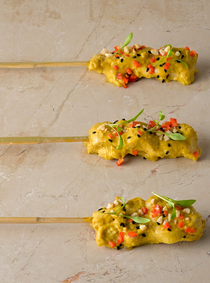 Chicken satay skewer, almond crumb, coriander cress, chopped chilli, nigella seed (GF)