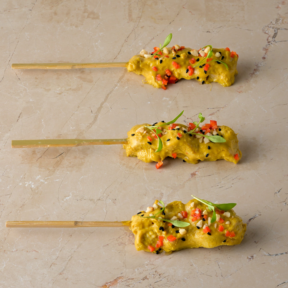 Chicken satay skewer, almond crumb, coriander cress, chopped chilli, nigella seed (GF)
