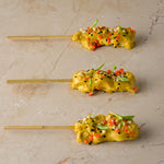 Chicken satay skewer, almond crumb, coriander cress, chopped chilli, nigella seed (GF)