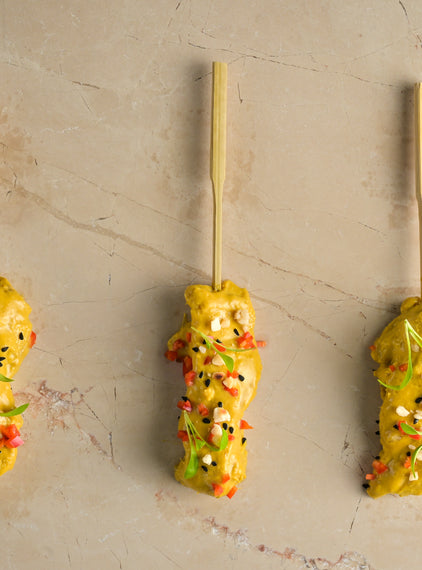 Chicken satay skewer, almond crumb, coriander cress, chopped chilli, nigella seed (GF)