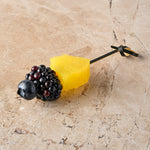 Compressed pineapple, blackberry, blueberry skewer
