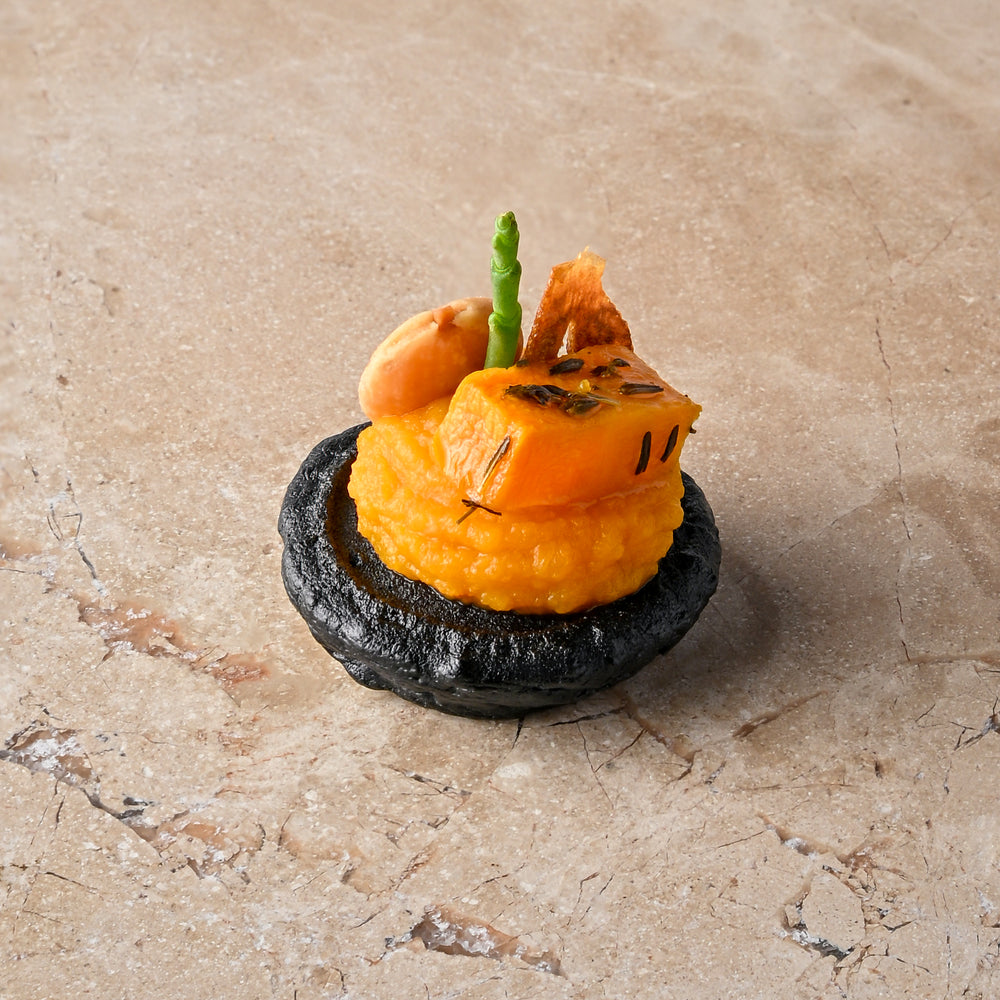 Cumin and charcoal blini, roast butternut, confit garlic butternut puree, almond
