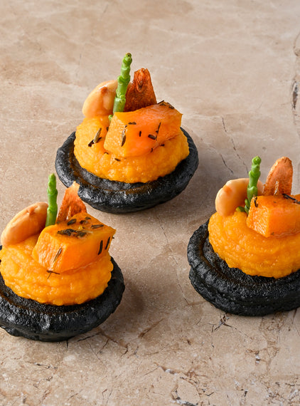 Cumin and charcoal blini, roast butternut, confit garlic butternut puree, almond