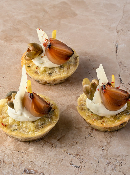 Cheddar and sauté onion frittata, aged Manchego, caper, balsamic shallot, zest, lemon crème