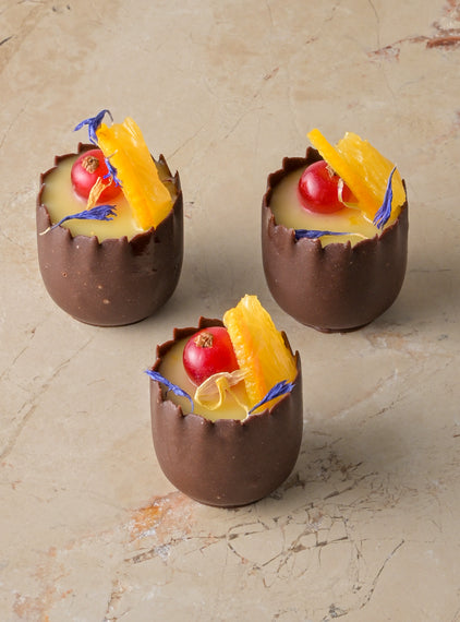 Orange cardamom posset, chocolate cup, red current, fresh orange, zest (GF)