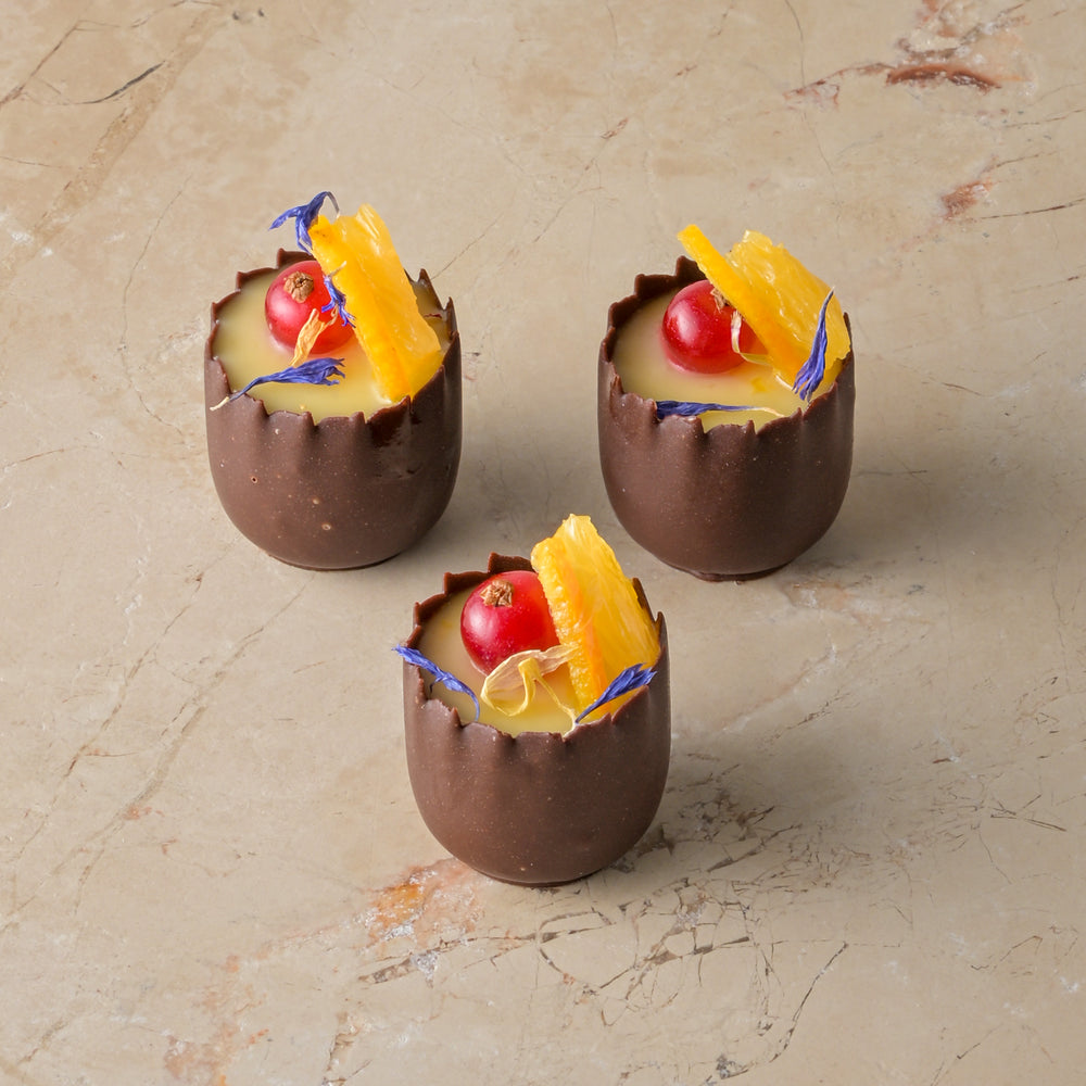Orange cardamom posset, chocolate cup, red current, fresh orange, zest (GF)