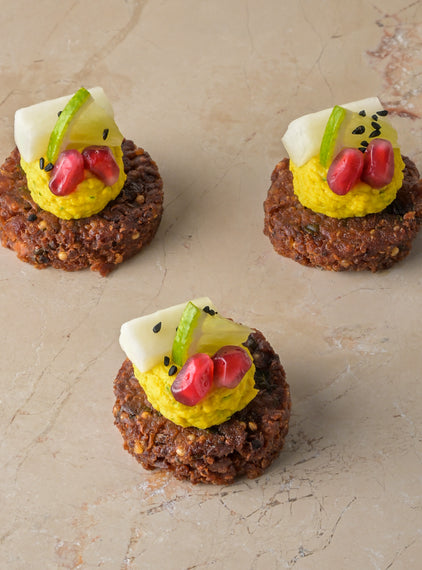 Quinoa and coriander seed falafel, tahini lime hummus, pomegranate, pickled kohlrabi