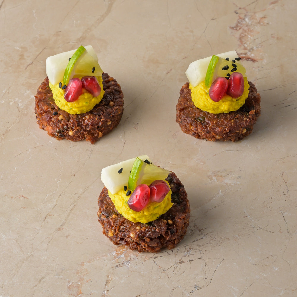 Quinoa and coriander seed falafel, tahini lime hummus, pomegranate, pickled kohlrabi