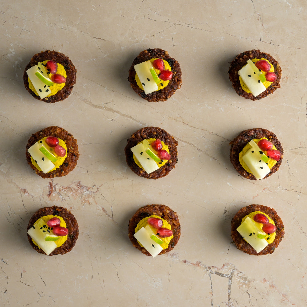 Quinoa and coriander seed falafel, tahini lime hummus, pomegranate, pickled kohlrabi