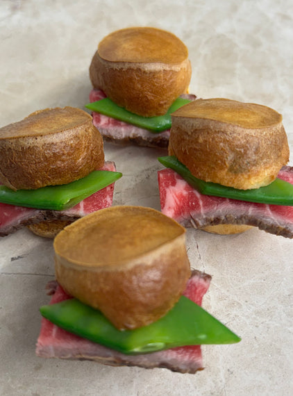 Rare roast beef Yorkshire puddings, mange tout, horseradish crème fraiche