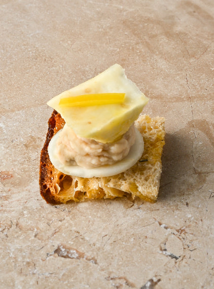 Salted thyme oil toast, cannellini bean and pink pepper puree, roast celeriac, preserved lemon