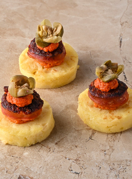 Seared chorizo, tortilla, oregano and tomato puree, caper flower