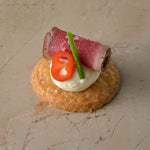 Seared carpaccio sirloin of beef, Dijon mustard crème, fresh chilli, chive, shortbread (GF)