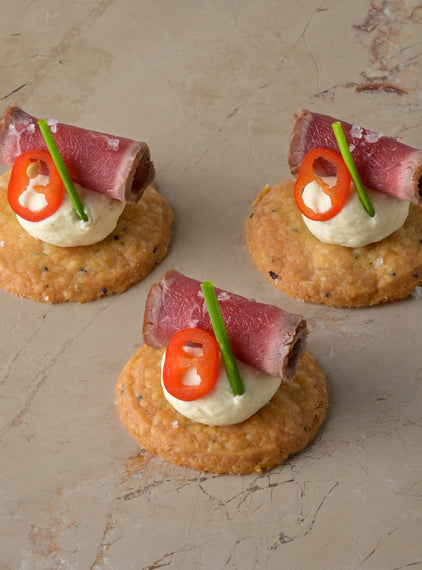 Seared carpaccio sirloin of beef, Dijon mustard crème, fresh chilli, chive, shortbread (GF)