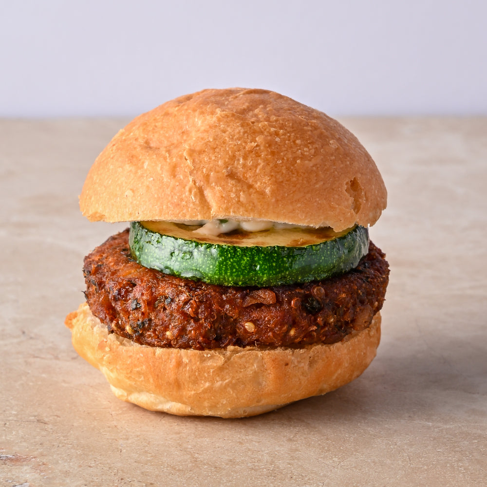 Quinoa and coriander falafel burger, fried courgette, tahini lime aioli, fresh mint leaf