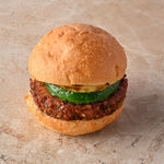 Quinoa and coriander falafel burger, fried courgette, tahini lime aioli, fresh mint leaf