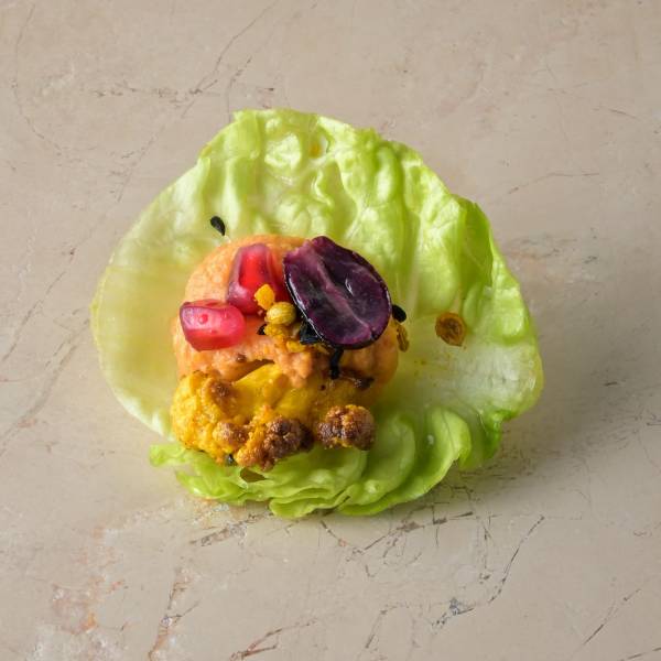 Harissa red pepper hummus, ras-el-hanout roast cauliflower, pomegranate, blushed grape, baby gem_1 img